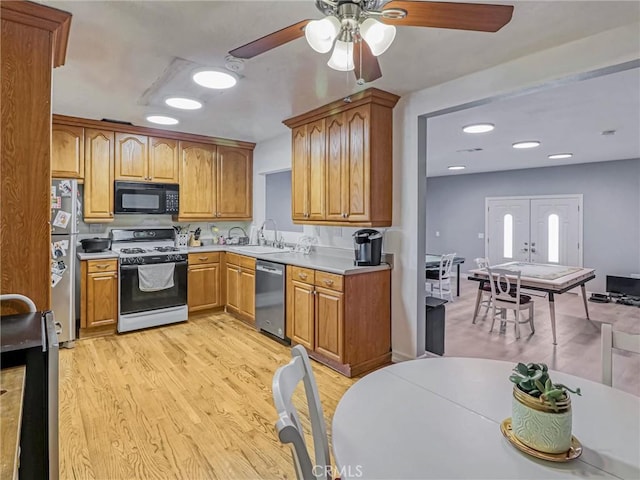 5436 Bonfair Ave, Lakewood, CA 90712 - kitchen featuring stainless steel appliances, a sink, a ceiling fan, light wood-style flooring, and light countertops