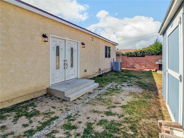 5436 Bonfair Ave, Lakewood, CA 90712 - entrance to property with stucco siding, french doors, and central AC