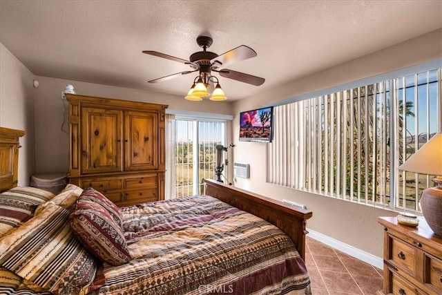 380 Mack Ln Unit 29, Palms, CA 92277 - bedroom with tile patterned floors, baseboards, ceiling fan, and a textured ceiling