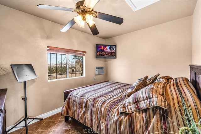 380 Mack Ln Unit 29, Palms, CA 92277 - bedroom with tile patterned flooring, baseboards, ceiling fan, and a wall mounted air conditioner