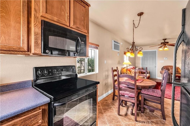 380 Mack Ln Unit 29, Palms, CA 92277 - kitchen featuring black appliances, brown cabinets, ceiling fan, light tile patterned floors, and baseboards