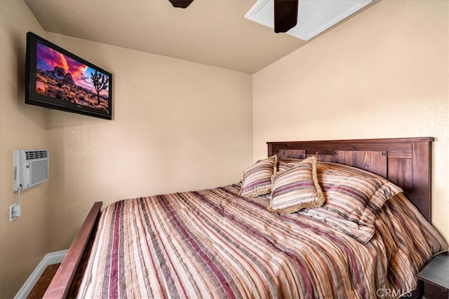380 Mack Ln Unit 29, Palms, CA 92277 - bedroom with a wall mounted air conditioner, ceiling fan, and baseboards