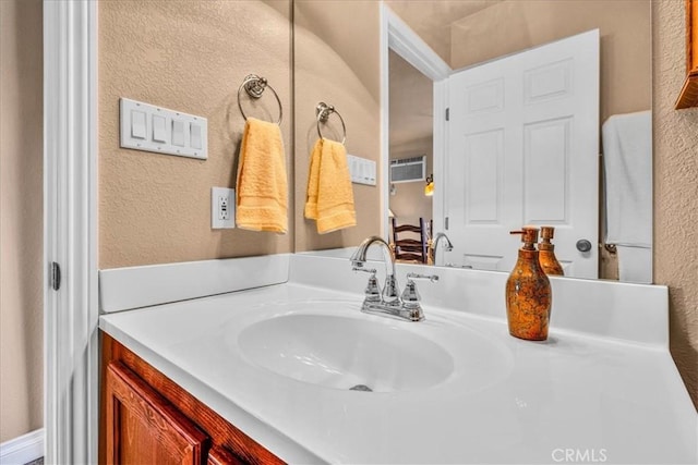 380 Mack Ln Unit 29, Palms, CA 92277 - bathroom featuring a textured wall, vanity, and a wall mounted air conditioner