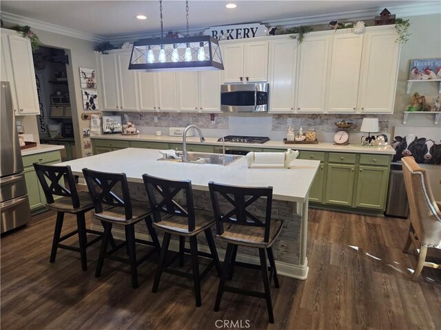25687 Red Hawk Rd, Corona, CA 92883 - kitchen featuring green cabinetry, appliances with stainless steel finishes, a sink, crown molding, and light countertops
