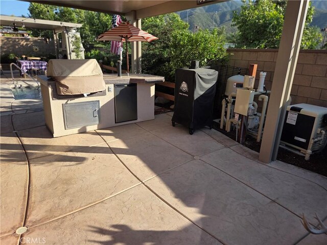 25687 Red Hawk Rd, Corona, CA 92883 - view of patio with an outdoor kitchen and a mountain view