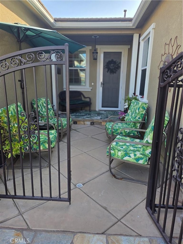 25687 Red Hawk Rd, Corona, CA 92883 - doorway to property featuring stucco siding and a gate