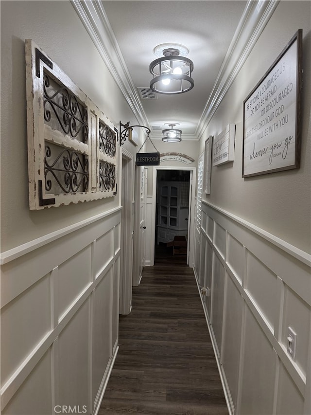 25687 Red Hawk Rd, Corona, CA 92883 - hallway featuring crown molding, a decorative wall, dark wood-style flooring, and a wainscoted wall