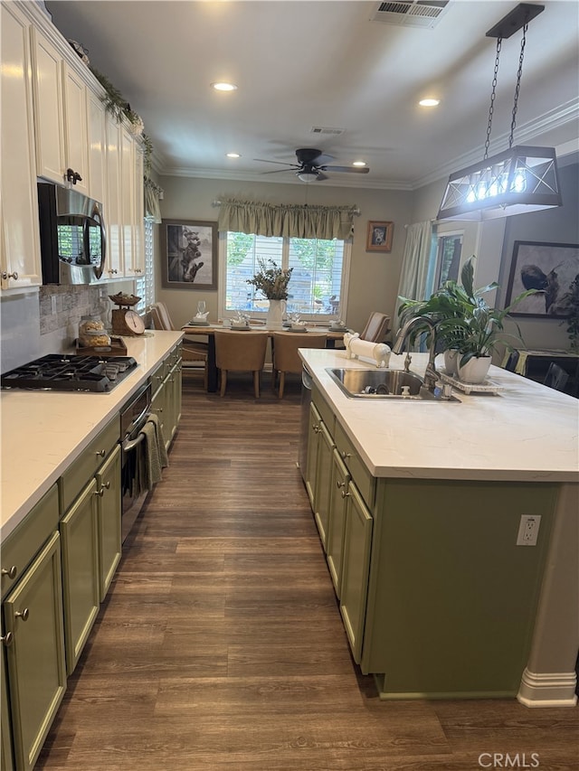 25687 Red Hawk Rd, Corona, CA 92883 - kitchen with appliances with stainless steel finishes, ornamental molding, a kitchen island, light countertops, and ceiling fan