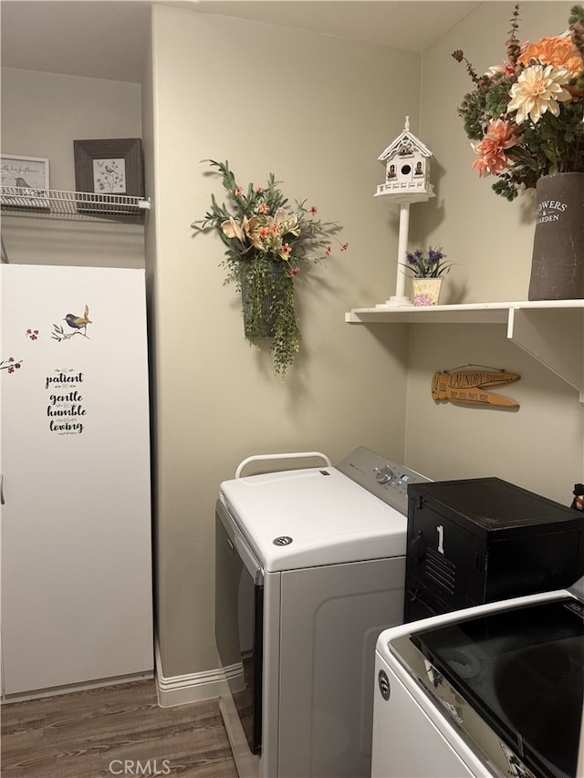 25687 Red Hawk Rd, Corona, CA 92883 - washroom with independent washer and dryer and wood finished floors