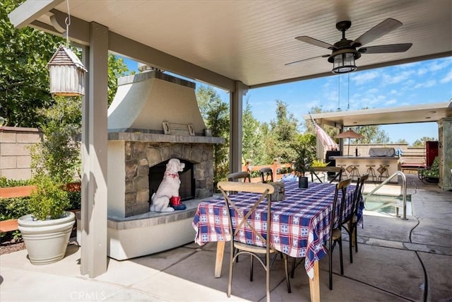 25687 Red Hawk Rd, Corona, CA 92883 - view of patio / terrace with an outdoor stone fireplace and a ceiling fan