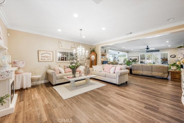 25687 Red Hawk Rd, Corona, CA 92883 - living room with wood finished floors, recessed lighting, a chandelier, ornamental molding, and ceiling fan