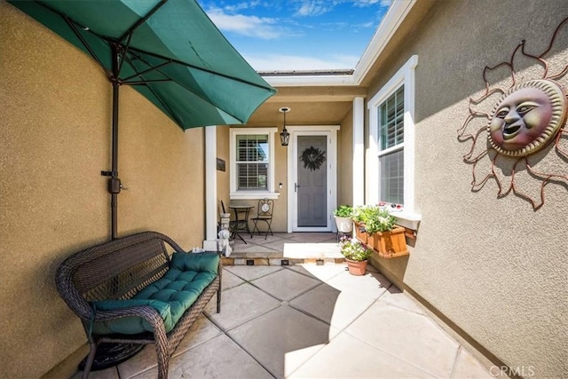 25687 Red Hawk Rd, Corona, CA 92883 - view of exterior entry featuring stucco siding and a patio