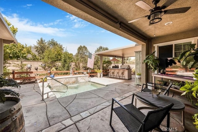 25687 Red Hawk Rd, Corona, CA 92883 - fenced backyard featuring an outdoor kitchen, a patio, and a ceiling fan