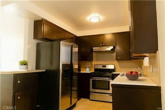 919 E Ln Palma Dr Unit 4, Inglewood, CA 90301 - kitchen featuring appliances with stainless steel finishes, under cabinet range hood, light countertops, and dark brown cabinetry