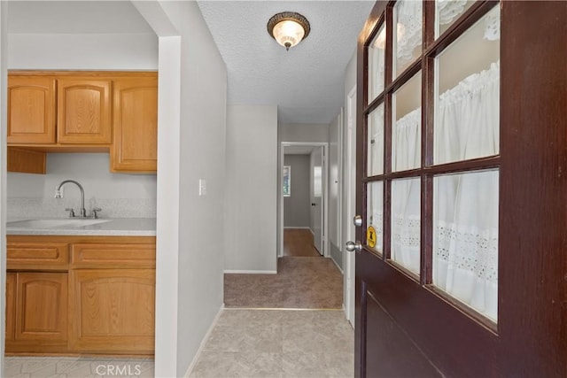 26111 Abdale St, Newhall, CA 91321 - bar featuring a sink, baseboards, a textured ceiling, and light colored carpet