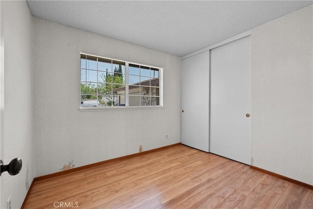 26111 Abdale St, Newhall, CA 91321 - unfurnished bedroom with light wood-type flooring, a closet, and baseboards