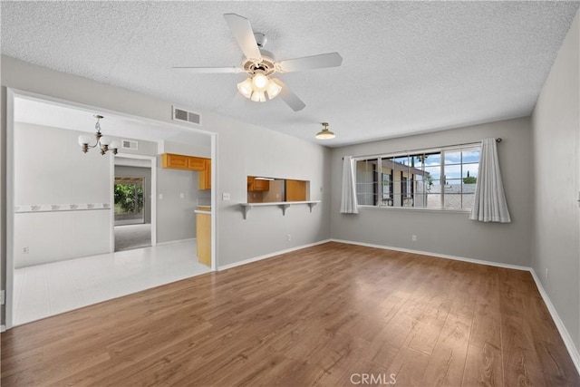 26111 Abdale St, Newhall, CA 91321 - unfurnished living room with a chandelier, plenty of natural light, a textured ceiling, wood finished floors, and ceiling fan