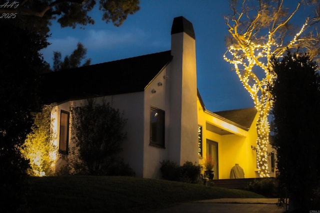 3030 Ibsen, Point Loma, CA 92106 - property exterior at night featuring a chimney and stucco siding
