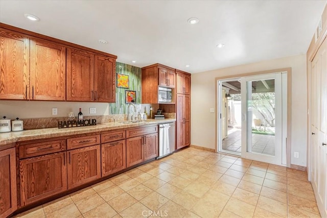 1256 Bostonia St Unit B, El Cajon, CA 92021 - kitchen with appliances with stainless steel finishes, a sink, brown cabinetry, recessed lighting, and light stone countertops