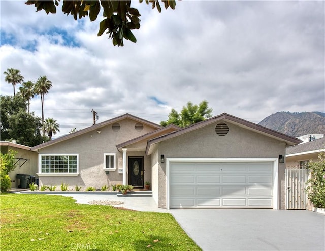 2407 E Woodlyn Rd, Pasadena, CA 91104 - single story home with a garage, stucco siding, concrete driveway, and a mountain view