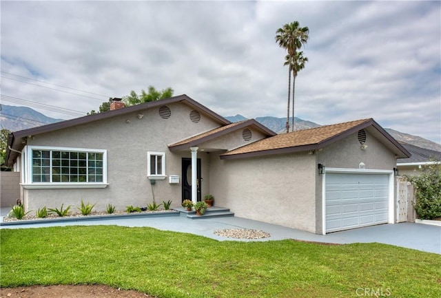 2407 E Woodlyn Rd, Pasadena, CA 91104 - ranch-style home featuring stucco siding, an attached garage, a mountain view, a front lawn, and concrete driveway