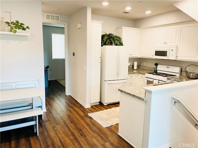 14120 W Willow Ln, Van Nuys, CA 91405 - kitchen with white appliances, white cabinets, a peninsula, dark wood-style floors, and recessed lighting