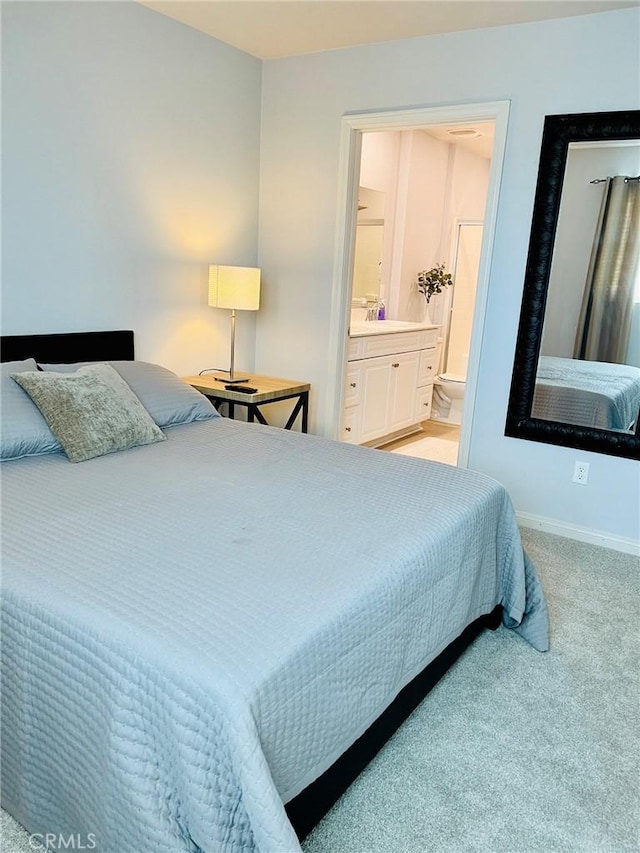 14120 W Willow Ln, Van Nuys, CA 91405 - bedroom featuring light colored carpet and ensuite bath