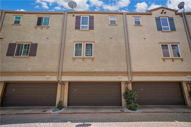 14120 W Willow Ln, Van Nuys, CA 91405 - back of property with a garage, driveway, and stucco siding