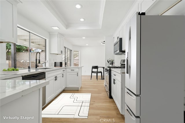 6340 N Azalea Ave, San Bernardino, CA 92407 - kitchen with appliances with stainless steel finishes, recessed lighting, a sink, a raised ceiling, and light wood finished floors