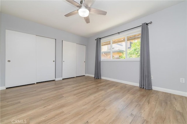 2244 Molino Ave, Signal Hill, CA 90755 - unfurnished bedroom with two closets, light wood finished floors, baseboards, and a ceiling fan