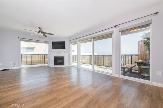 2244 Molino Ave, Signal Hill, CA 90755 - unfurnished living room with wood finished floors, a ceiling fan, a fireplace, and baseboards