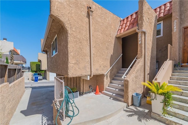 2244 Molino Ave, Signal Hill, CA 90755 - view of side of property featuring stucco siding, stairway, a tiled roof, and a patio area