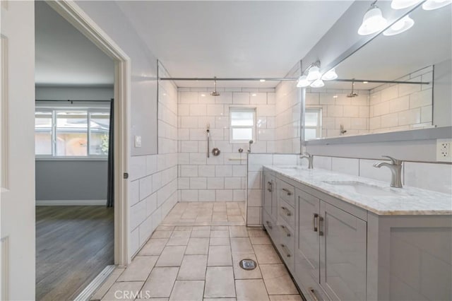 2244 Molino Ave, Signal Hill, CA 90755 - bathroom with double vanity, tiled shower, tile patterned floors, and baseboards