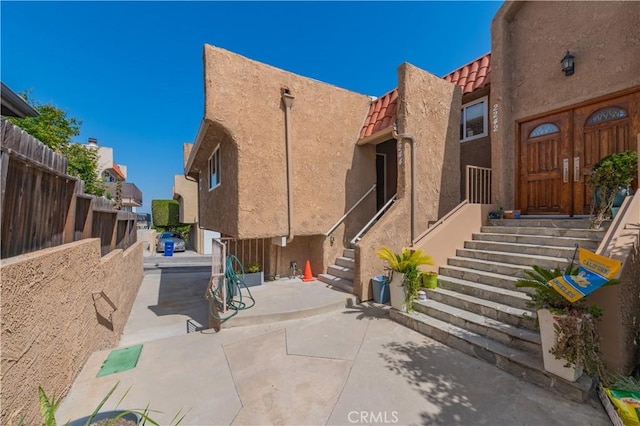 2244 Molino Ave, Signal Hill, CA 90755 - view of home's exterior featuring stucco siding, a tile roof, and a patio