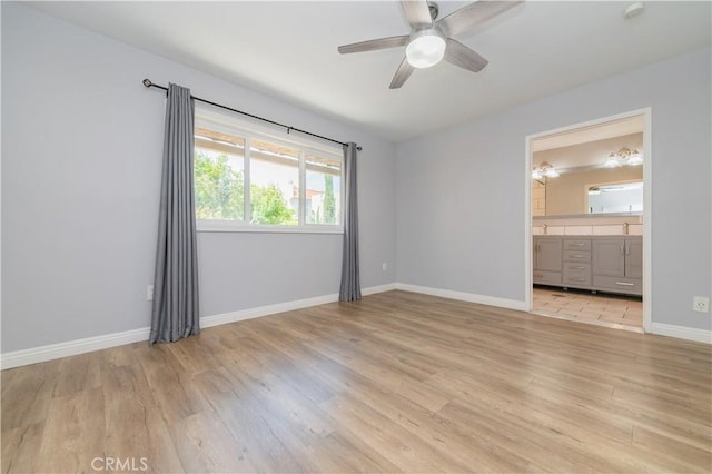 2244 Molino Ave, Signal Hill, CA 90755 - unfurnished bedroom featuring light wood-style floors, baseboards, ensuite bathroom, and ceiling fan