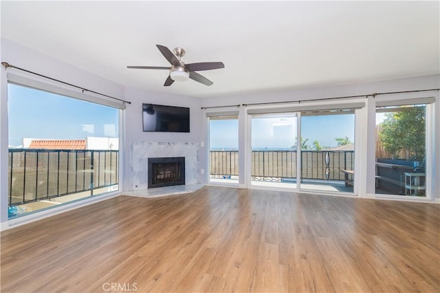 2244 Molino Ave, Signal Hill, CA 90755 - unfurnished living room featuring wood finished floors, ceiling fan, and a high end fireplace