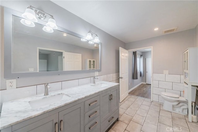 2244 Molino Ave, Signal Hill, CA 90755 - bathroom featuring double vanity, tile walls, toilet, and tile patterned flooring