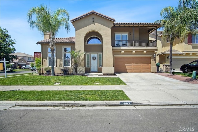 2983 Orchid Ln, Turlock, CA 95382 - view of front facade featuring a tiled roof, stucco siding, a balcony, a front yard, and an attached garage