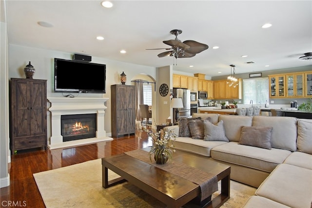 2983 Orchid Ln, Turlock, CA 95382 - living room featuring ceiling fan, a glass covered fireplace, recessed lighting, wood finished floors, and baseboards