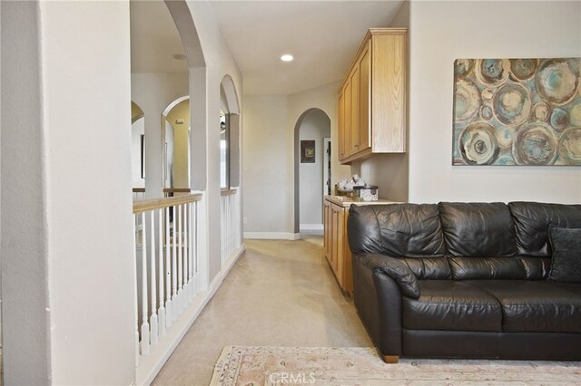 2983 Orchid Ln, Turlock, CA 95382 - living room featuring arched walkways, light carpet, baseboards, and recessed lighting