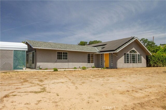 33708 Bronco Ln, Squaw Valley, CA 93675 - ranch-style home with stucco siding and roof mounted solar panels
