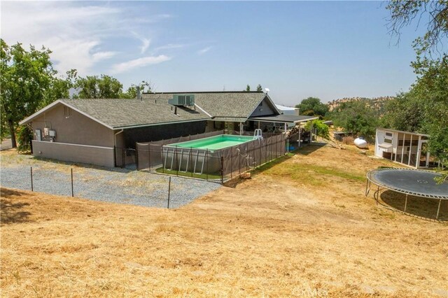 33708 Bronco Ln, Squaw Valley, CA 93675 - back of house featuring a trampoline and cooling unit