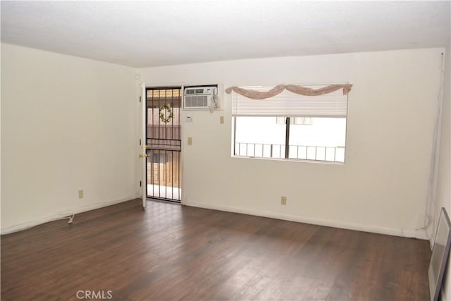 15351 Orange Ave Unit 25, Paramount, CA 90723 - unfurnished room with wood finished floors, a wall unit AC, and baseboards