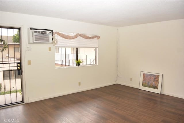 15351 Orange Ave Unit 25, Paramount, CA 90723 - spare room featuring an AC wall unit, wood finished floors, and baseboards