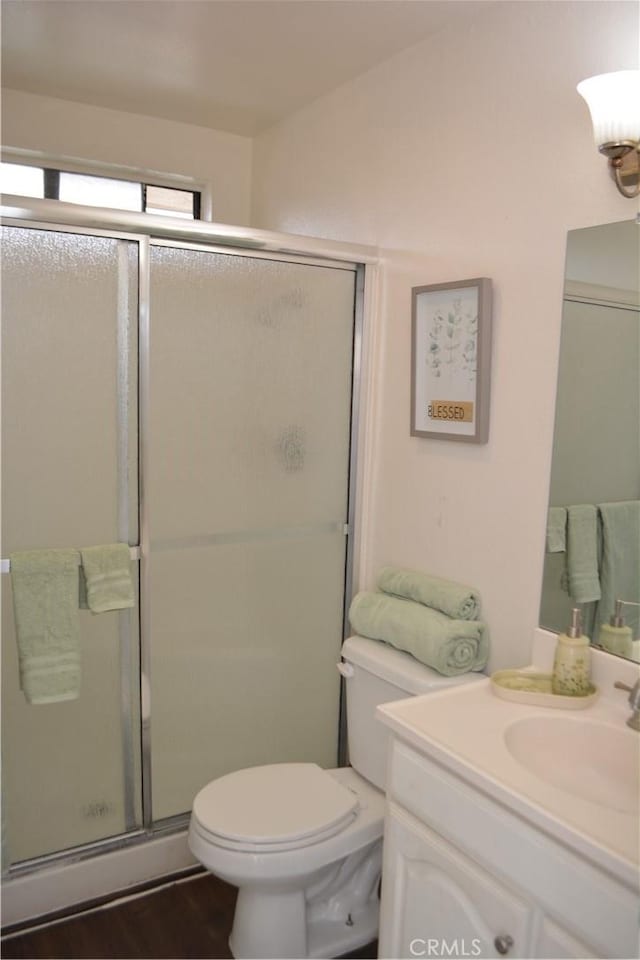 15351 Orange Ave Unit 25, Paramount, CA 90723 - full bath with toilet, vanity, a shower stall, and wood finished floors