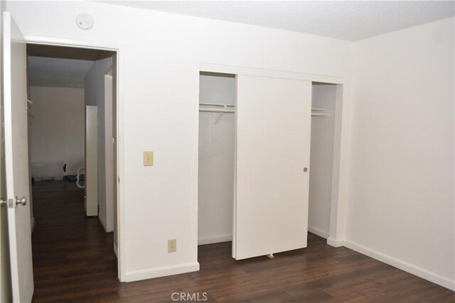 15351 Orange Ave Unit 25, Paramount, CA 90723 - unfurnished bedroom with dark wood finished floors and a closet