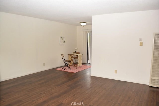 15351 Orange Ave Unit 25, Paramount, CA 90723 - unfurnished room with a heating unit, dark wood-style floors, and baseboards