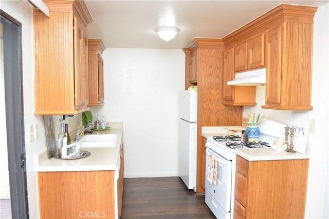 15351 Orange Ave Unit 25, Paramount, CA 90723 - kitchen featuring white appliances, under cabinet range hood, a sink, light countertops, and dark wood-style flooring