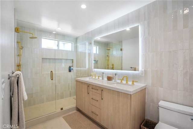 11938 Whitewater Ln, Malibu, CA 90265 - bathroom with a shower stall, double vanity, tile walls, toilet, and tile patterned floors