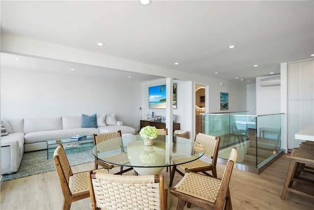 11938 Whitewater Ln, Malibu, CA 90265 - dining space with a wall mounted air conditioner, wood finished floors, recessed lighting, and arched walkways